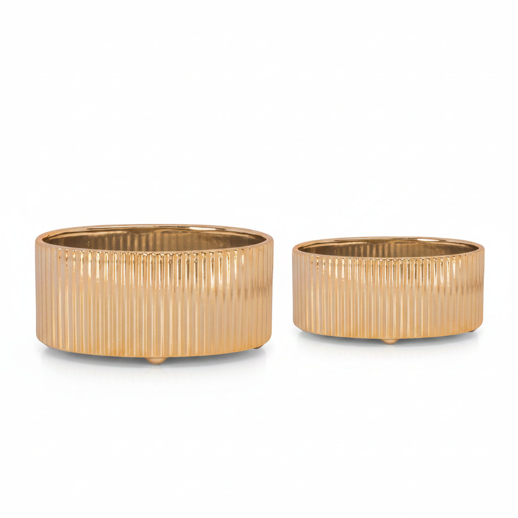 Two ceramic vases with a metallic silver finish, oval in shape, displayed one inside the other.