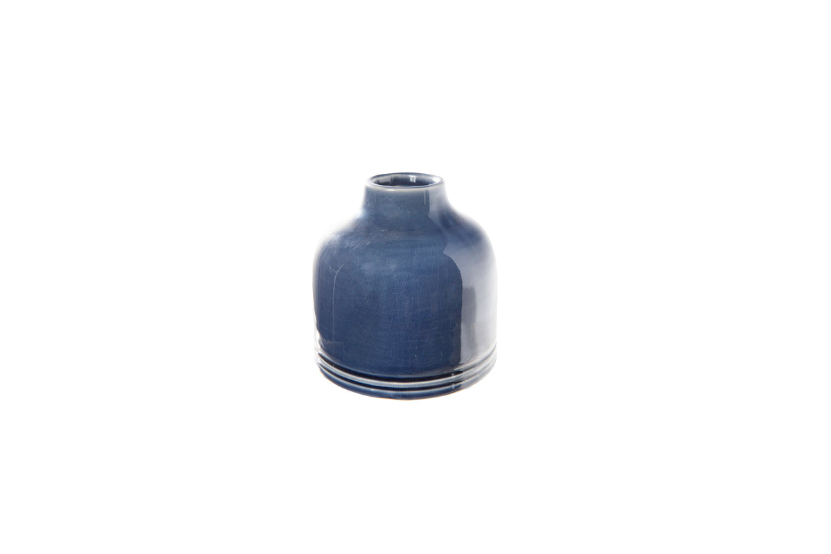 A ceramic round vase with a narrow mouth and a flat, banded bottom, finished in a dark blue color.