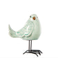Decorative bird sculpture on a stand with a white background