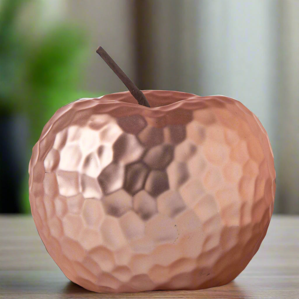 A ceramic apple figurine with a matte silver finish and a hammered design texture, featuring a stem.