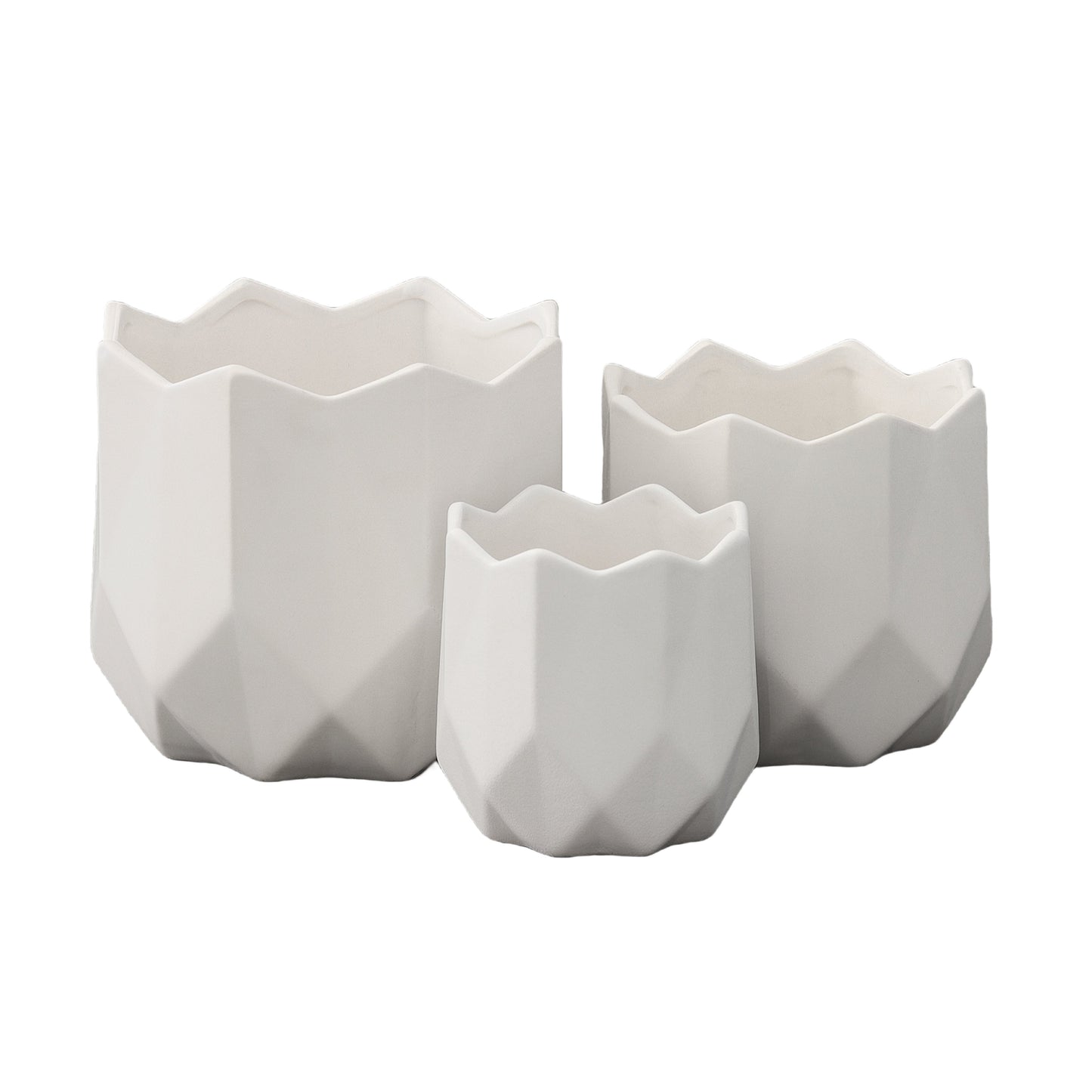 A set of three white ceramic round pots with a matte finish and a geometric design