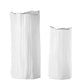 Two ceramic tall round vases with a matte finish, one in the background smaller in size and the other in the foreground larger in size, both with an irregular lip and embossed seamless column design, displayed against a white background.