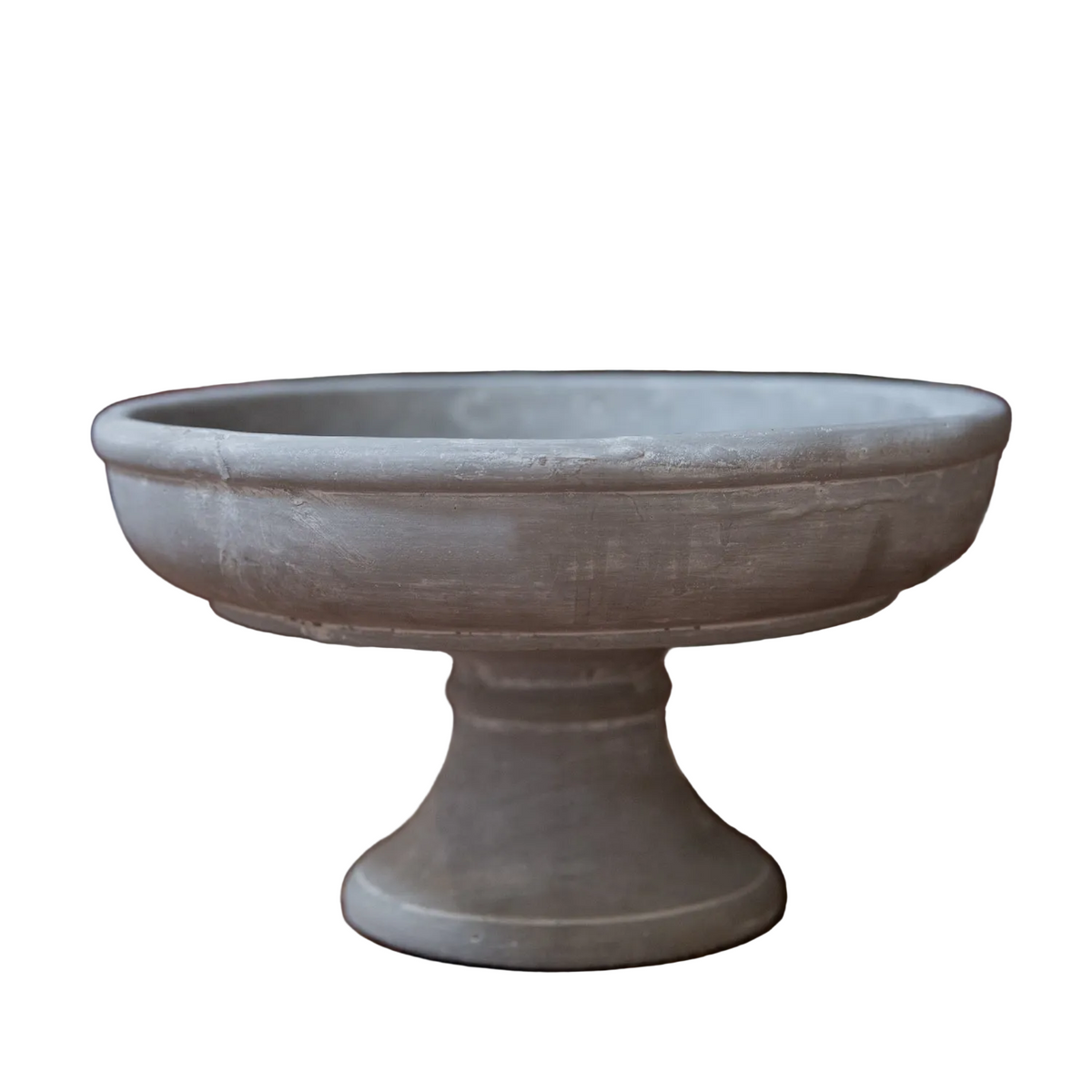 A round pedestal bowl or planter in a weathered gray stone or concrete finish, shown against a plain white background.