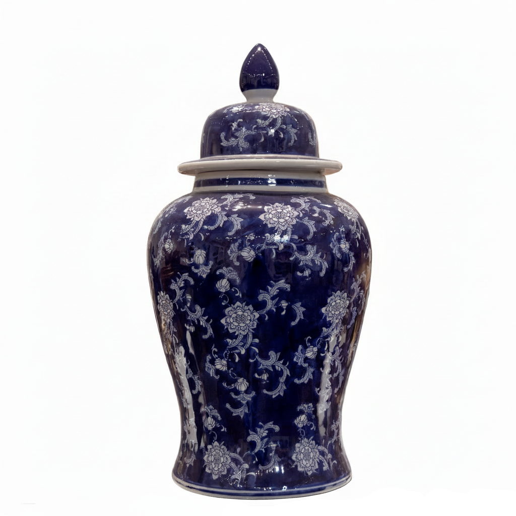 A traditional Chinese porcelain ginger jar with a lid, featuring a deep cobalt blue glaze and intricate white floral patterns, set against a plain white background.
