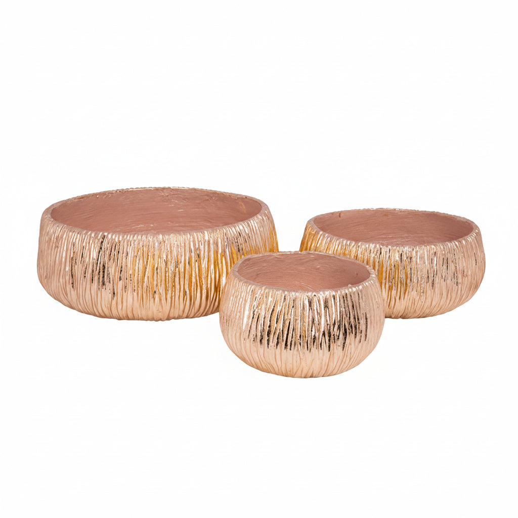 Three decorative cylindrical objects with a textured surface on a white background