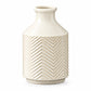 A white ceramic round vase with a chevron pattern design, a short neck, and a bottle ring mouth.