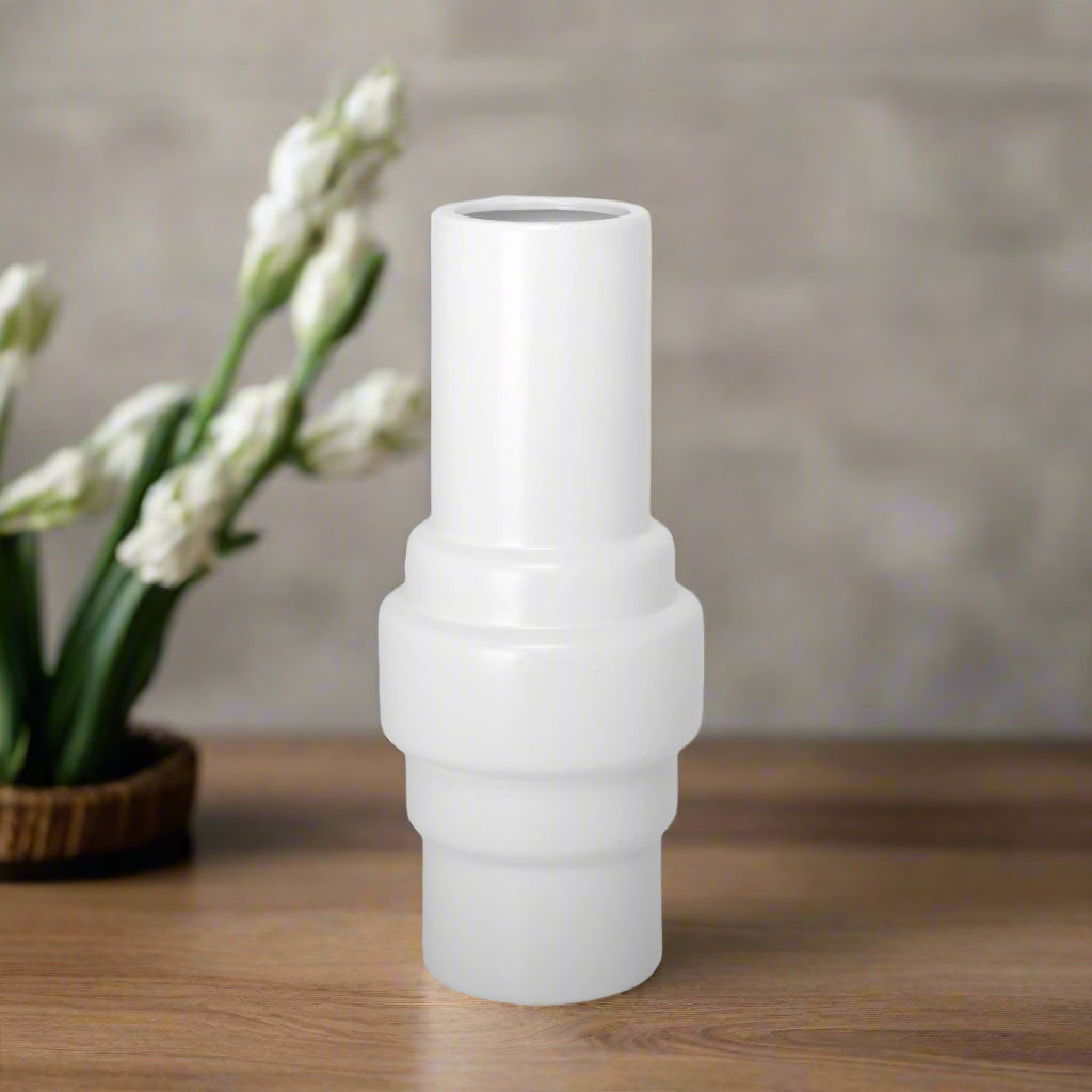 A white ceramic vase with a matte finish.