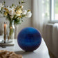 Blue spherical object on a white background