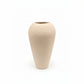 A textured ceramic vase with a tapered, bulbous shape and a wide flared rim, in a light beige color, shown against a plain white background.