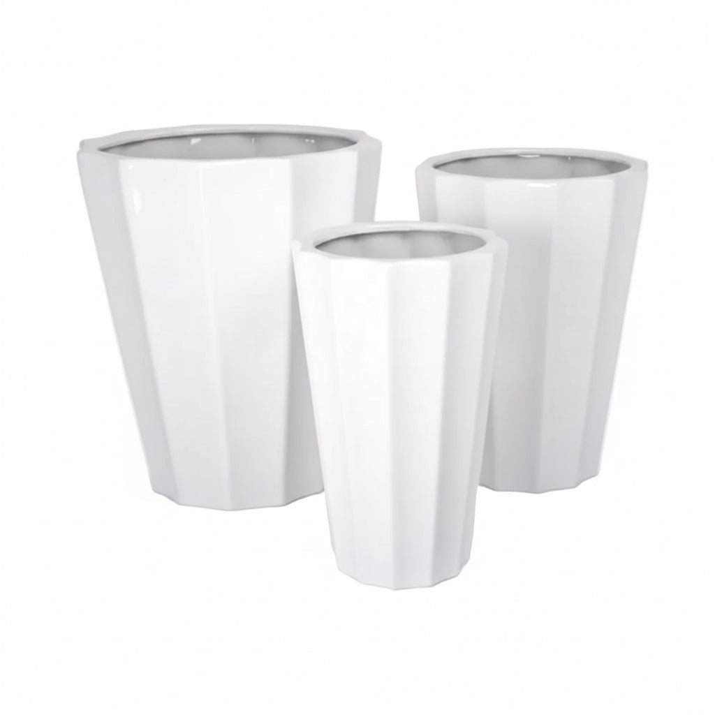 Set of three white planters of different sizes on a white background