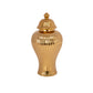 A gold ceramic urn vase with a ribbed design and a lid.