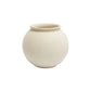 A small round ceramic pot with a wide, slightly flared rim, in a matte off-white or cream finish, centered on a clean white background.