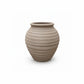 Beige ceramic vase with ribbed texture on a white background