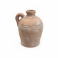A rustic terracotta clay jug with a single loop handle and a short neck, shown on a plain white background.