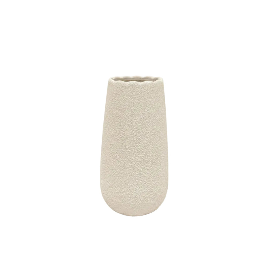 A small textured ceramic vase in a light beige or cream color, standing upright against a solid white background.
