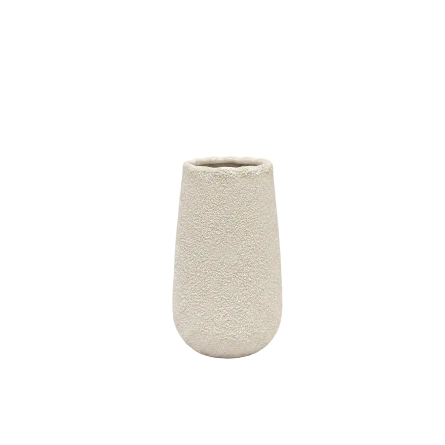A small textured ceramic vase in a light beige or off-white color, standing upright against a plain white background.