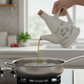 Jamaica Ceramic 24 oz. Olive Oil Pourer with Embossed Olives, Label, Cork Lid, and Handle