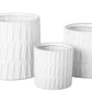 A set of three black ceramic round pots with a matte finish and embossed layered banded spike pattern