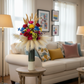 Colorful flower arrangement with pampas grass in a vase on a white background