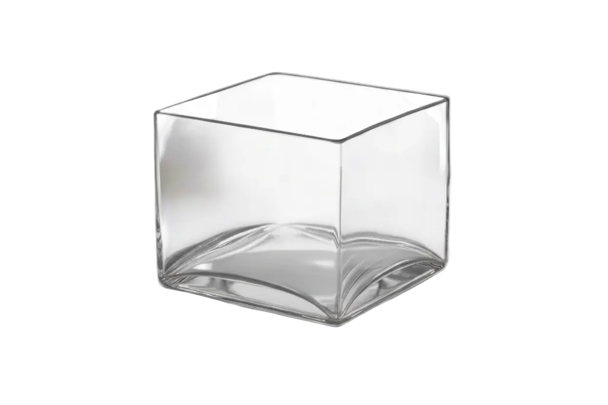 Clear glass cube on a white surface with a blurred background